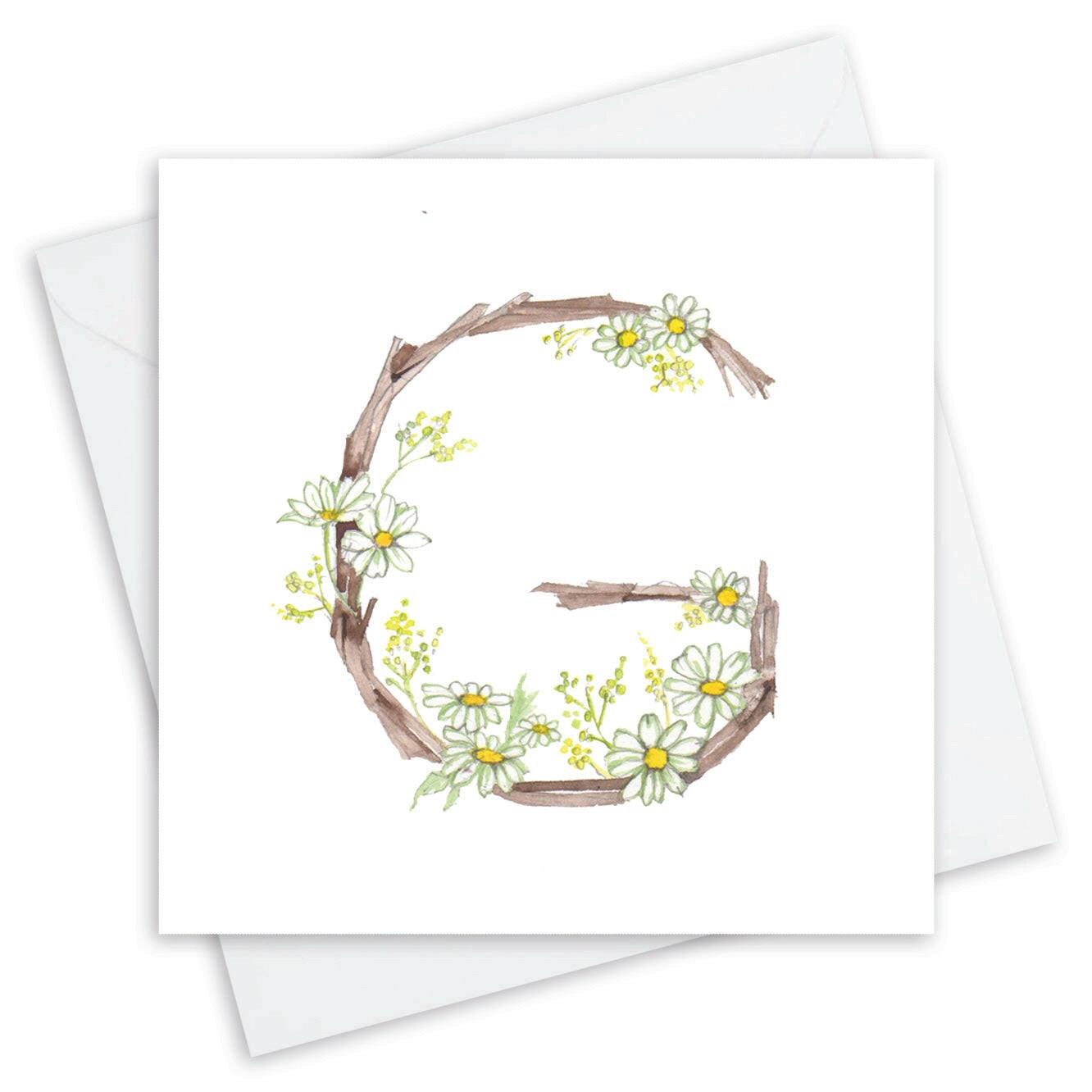 Handcrafted Crumble and Core greeting card with letter G, floral and twig design, white envelope