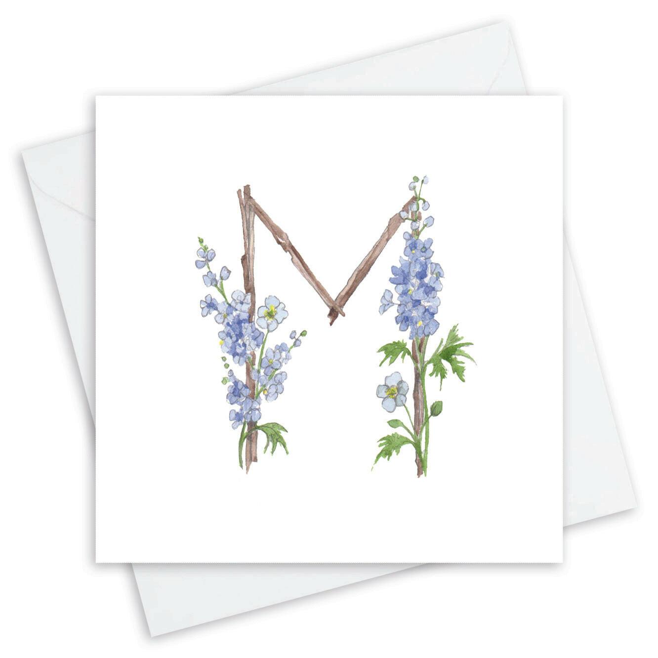 Handcrafted Crumble and Core card with floral letter M and blue delphinium design