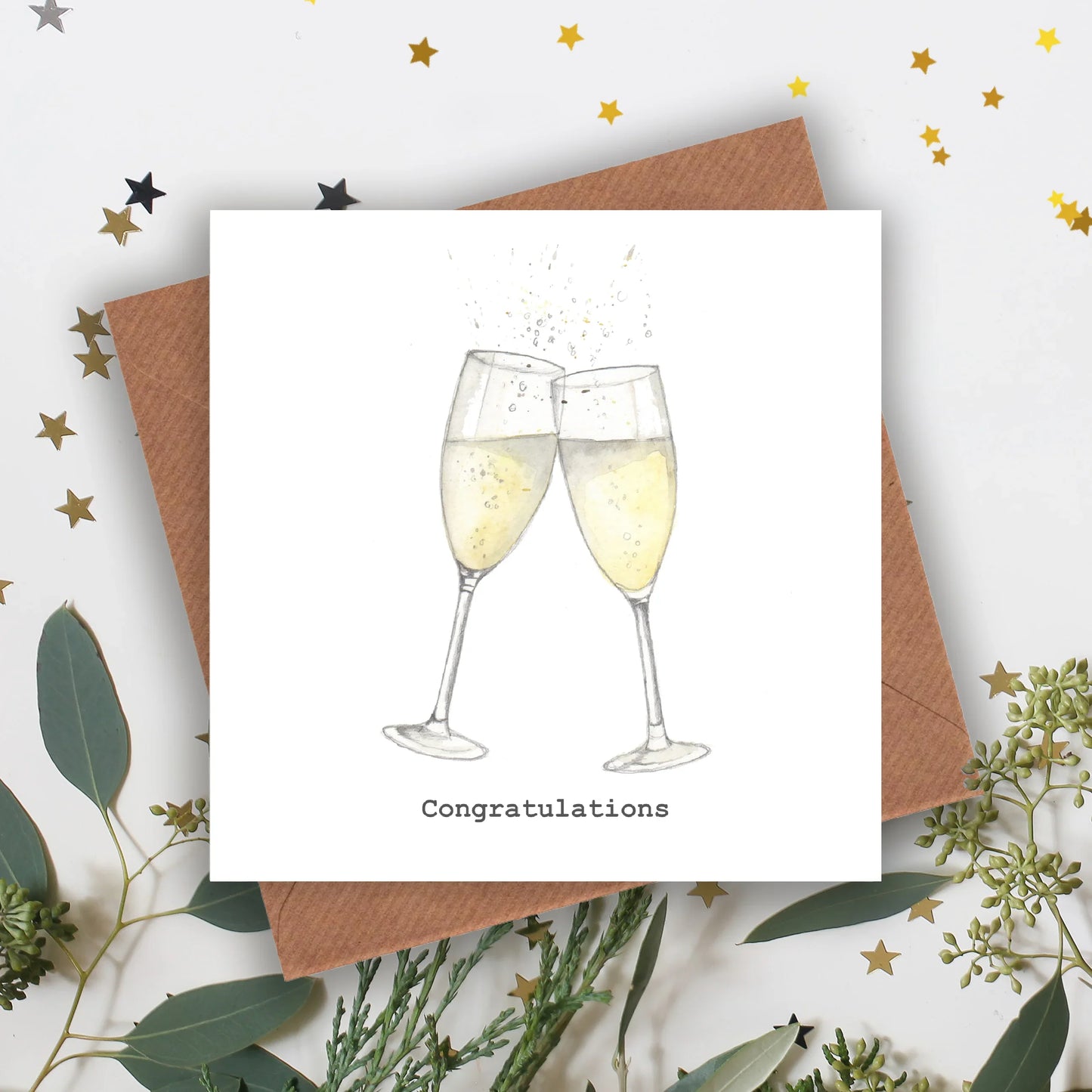 Crumble and Core handcrafted congratulations card with two clinking champagne glasses