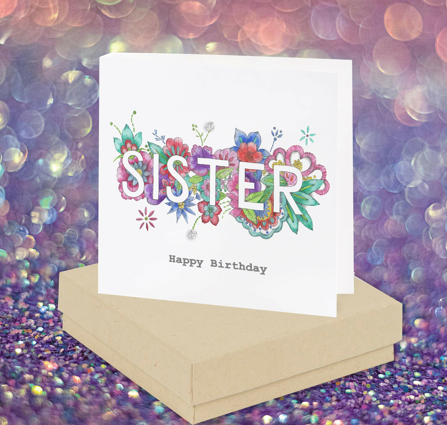 Handcrafted Crumble and Core sister birthday card with colorful floral design on a gift box